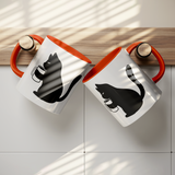 Black_Cat_Holding_Coffee_Mug_11oz_Ceram_Lifestyle_Hanging_Mockup.png