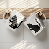 Black_Cat_Holding_Coffee_Mug_11oz_Ceram_Lifestyle_Hanging_Mockup.png