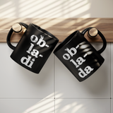 Ob_La_Di_Ob_La_Da_11_oz_Black_Coffee_Mug_Lifestyle_Hanging_Mugs_Mockup.png_15559206